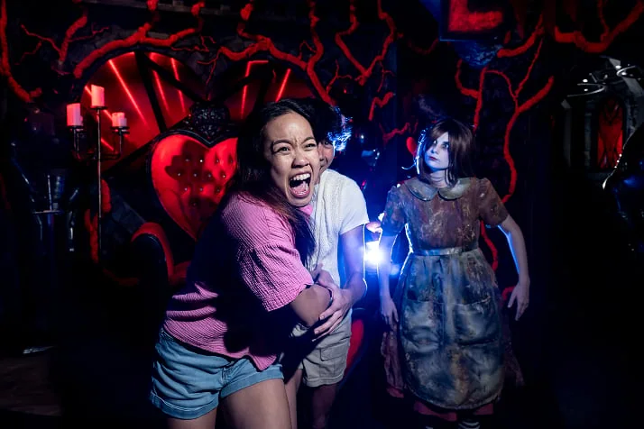 Guests encountering a scare performer at Howl-O-Scream; official Busch Gardens Tampa Bay 2026 event-page photograph.